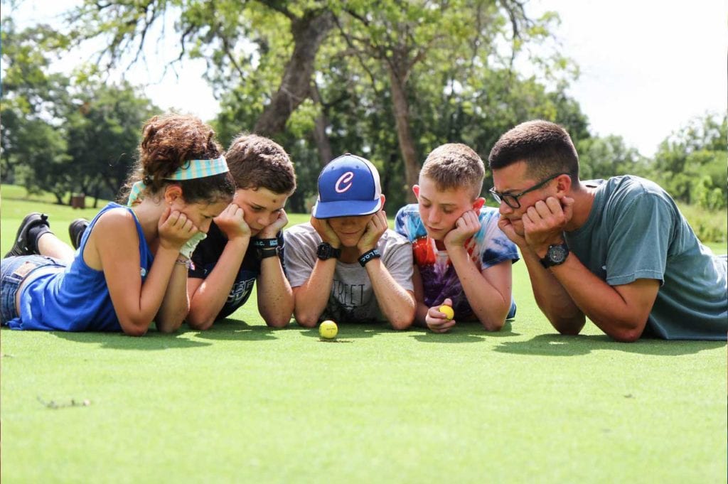 Campers looking at a golf ball